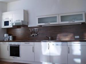 a kitchen with white cabinets and stainless steel appliances at Wohnung in Kappl mit Eigenem Balkon in Kappl