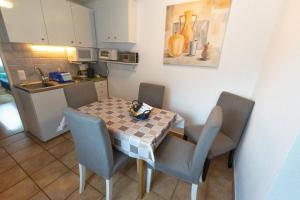 una pequeña cocina con mesa y sillas en una habitación en Geräumige Ferienwohnung mit zwei Schlafzimmern, ideal für eine Familie, en Flattach