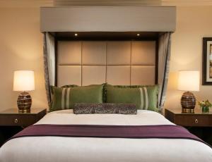 a bedroom with a large bed with a large headboard at Grand Reserve at The Meritage in Napa