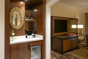 a hotel room with a television and a desk at Grand Reserve at The Meritage in Napa