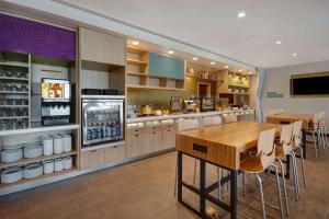 a large kitchen with a table and chairs at Home2 Suites By Hilton Garden Grove in Garden Grove