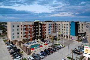an aerial view of a hotel with a parking lot at Home2 Suites Galveston, Tx in Galveston