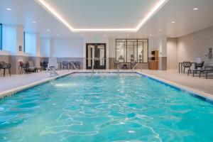 a large pool with blue water in a building at Embassy Suites By Hilton Asheville Downtown in Asheville