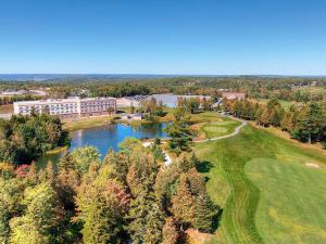 an aerial view of a building and a lake at Radisson Kingswood Hotel & Suites, Fredericton in Fredericton