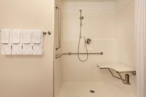 a white bathroom with a shower and a toilet at Park Inn by Radisson, Calgary Airport North, AB in Calgary +37 photos