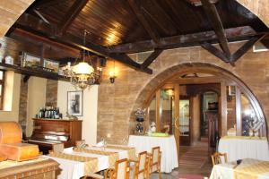 a restaurant with tables and chairs in a room at Motel Alas in Banja Luka