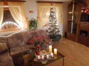 a living room with a christmas tree and candles at Ferienhaus Erzgebirge Familie Ziller, Crottendorf in Crottendorf
