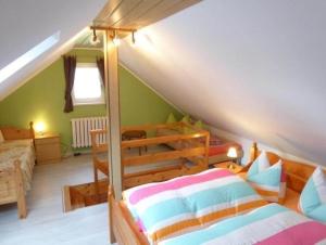 a attic room with a bed and a bed at Ferienhaus Erzgebirge Familie Ziller, Crottendorf in Crottendorf