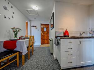 a kitchen with a table and a dining room at 1 Bed in Troutbeck nr Ullswater SZ254 in Troutbeck