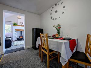 a dining room with a table and chairs and a fireplace at 1 Bed in Troutbeck nr Ullswater SZ254 in Troutbeck