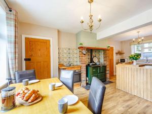 a kitchen and dining room with a table and chairs at 2 Bed in Northumblerland National Park 83586 in Rochester