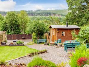 a cabin in a garden with a table and benches at 2 Bed in Northumblerland National Park 83586 in Rochester