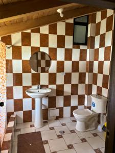 a bathroom with a sink and a toilet at Lodge Acopampa Inn in Carhuaz