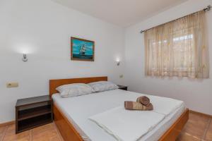 a bedroom with a bed with a hat on it at Apartments with a parking space Podaca, Makarska - 6050 in Podaca