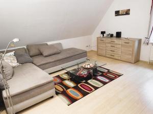 a living room with a couch and a glass table at Große Ferienwohnung in Bad Fallingbostel mit Garten, Grill und Terrasse in Bad Fallingbostel