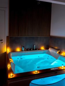 a large blue tub with lights in a room at Terra Mia in Piazza in Pompei