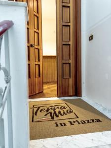 an entrance to a room with a welcome mat in front of a door at Terra Mia in Piazza in Pompei