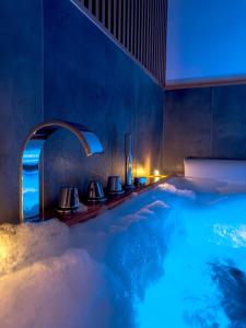 a jacuzzi tub in a hotel with a blue lighting at Terra Mia in Piazza in Pompei