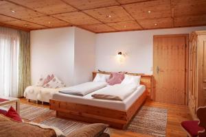 ein Schlafzimmer mit einem Bett und einer Couch in der Unterkunft Ferienhaus für sechs Erwachsene und drei Kinder mit Sauna und Kamin in Flachau