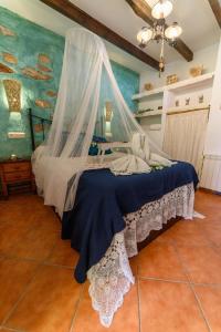 Schlafzimmer mit einem Bett mit Moskitonetz in der Unterkunft Ferienhaus in Laroya mit Whirlpool, gemeinschaftlichem Pool und Grill in Laroya