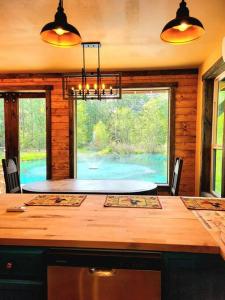 a kitchen with a table and a large window at Waterfront Houston Hide out In A Magical Forest in Waller
