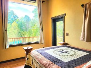 a bedroom with a bed and a large window at Waterfront Houston Hide out In A Magical Forest in Waller +26 photos