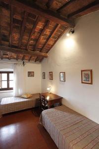 Habitación con 2 camas y mesa. en Casa Corzanello, en San Casciano in Val di Pesa