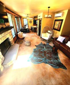a living room with a couch and a fireplace at Waterfront Houston Hide out In A Magical Forest in Waller