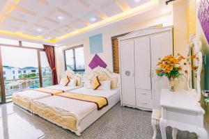 a bedroom with a large bed and a balcony at VILLA SB123 FLC SẦM SƠN in Sầm Sơn +16 photos