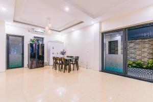 uma sala de jantar com mesa e cadeiras em VILLA SB123 FLC SẦM SƠN em Sam Son