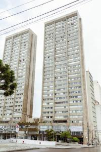 two tall buildings in a city with a street at A melhor opção no centro com vista panorâmica in Curitiba