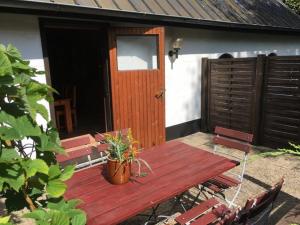 a wooden table and chairs in front of a house at Ferienhaus Knorburg im Herzen Nordfrieslands in Enge-Sande