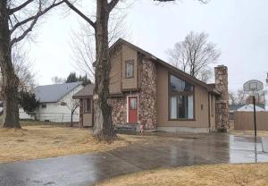 a house with a basketball hoop in front of it at Cozy Cabin in the City plus GYM in Winnemucca