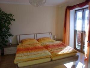 a large bed in a room with a window at Ferienwohnung in Grafing Bei München mit Großem Garten in Grafing