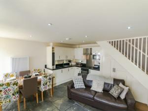 a living room with a couch and a dining room at 3 Bed in Aberdovey DY005 in Aberdyfi