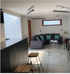 a living room with a couch and a table at Loft Volcanes Amecameca in Amecameca de Juárez
