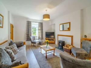 a living room with a couch and a table at 2 Bed in Glenridding 85425 in Glenridding