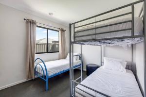 1 Schlafzimmer mit 2 Etagenbetten und einem Fenster in der Unterkunft Melton Moments - Cheerful and Breezy Living in Melton