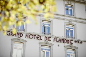 a building with a sign on the front of it at Grand Hotel de Flandre in Namur