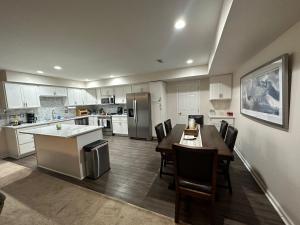 a large kitchen with a table and chairs in it at Niagara Shoreline Villa 1 in Tonawanda