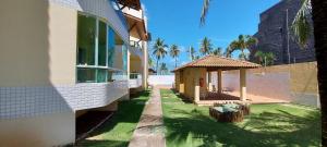 a house with a gazebo next to a building at COSTE0100 - Residencial Luz das Acácias in Salvador