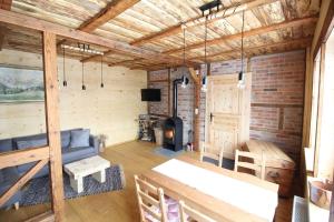 a living room with a couch and a fireplace at Ferienhaushälfte Gösselberg im Ferienhaus Anno Dazumal, wie zu Großmutters Zeiten, linke Seite in Klingenthal