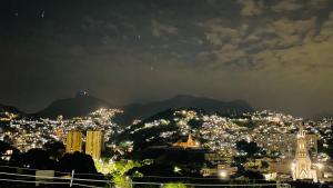 a view of a city at night at Panorama Inn in Rio de Janeiro