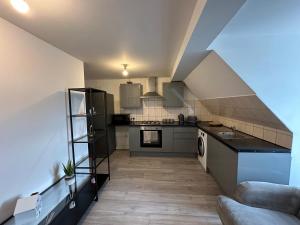 a kitchen with a staircase leading into a room at Wembley Stadium Serviced Apartments, 12mins to Central London in London
