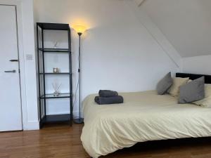 a bedroom with a bed with a light on it at Wembley Stadium Serviced Apartments, 12mins to Central London in London