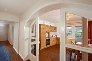 a kitchen with an archway and a dining room at Appartement in Neukirchen Am Großvenediger in Neukirchen am Großvenediger