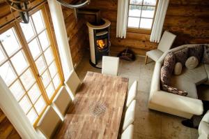 uma sala de estar com um sofá, uma mesa e uma lareira em Ferienhaus in Feldberg Schwarzwald mit Privatem Pool em Neuglashütten