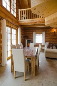 a dining room with a wooden table and chairs at Ferienhaus in Feldberg Schwarzwald mit Privatem Pool in Neuglashütten