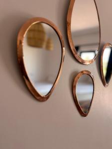 a group of mirrors hanging on a wall at Aghmat Lodge Guest house in Marrakech