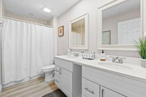 a white bathroom with a sink and a toilet at The Heather Marie - Stylish and Modern Rambler in Panama City